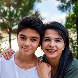 A smiling mother with her middle school-aged son, showcasing the community, emotional maturity, and academic success at Spell Well Montessori School in Spring, Texas.